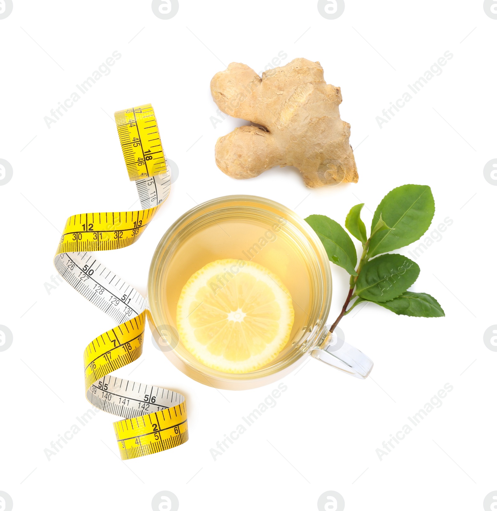 Photo of Diet herbal tea, measuring tape, ginger and leaves on white background, top view