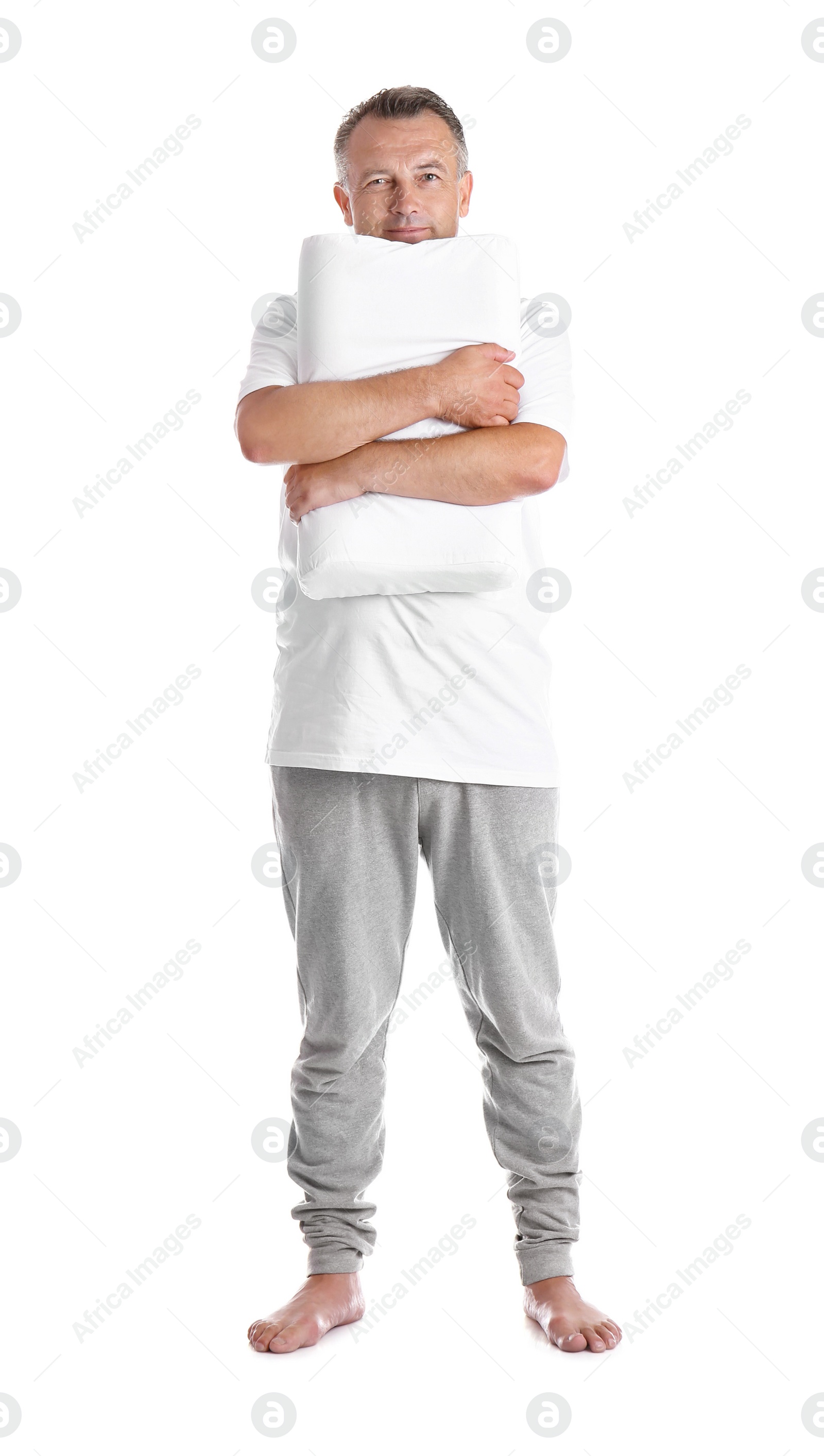 Photo of Man holding soft pillow on white background