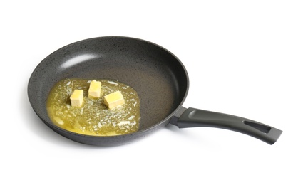 Frying pan with melting butter on white background