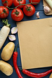 Blank recipe book and different ingredients on blue wooden table, flat lay. Space for text