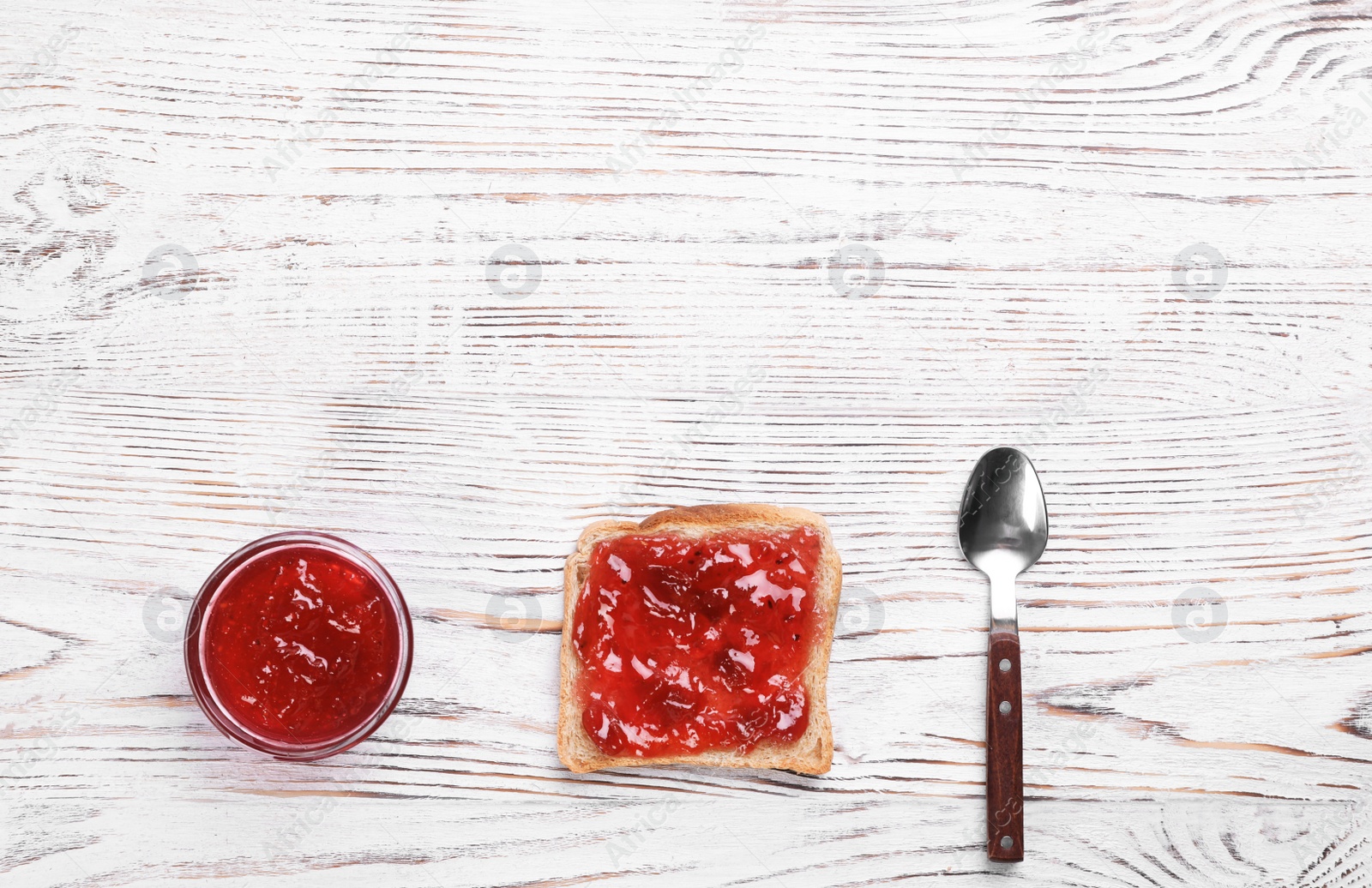 Photo of Toast with jam on wooden background, flat lay composition