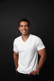 Photo of Handsome young African-American man on black background