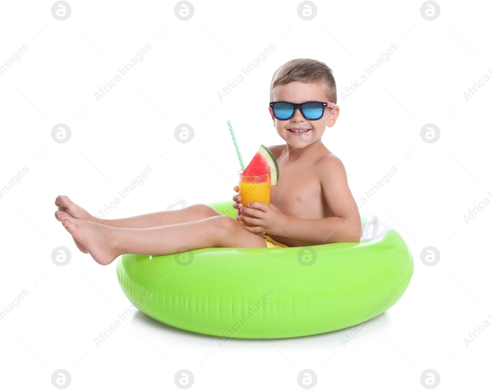 Photo of Cute little boy with inflatable ring and glass of cocktail on white background