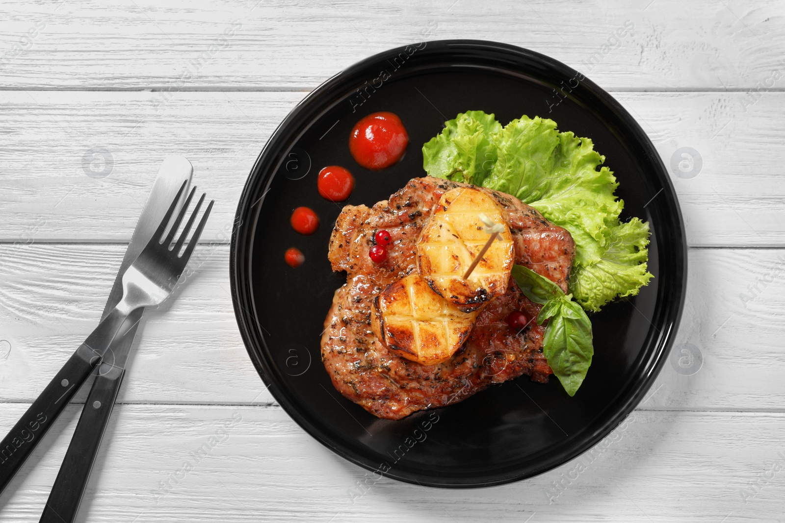 Photo of Plate with tasty grilled meat and potatoes on table, top view