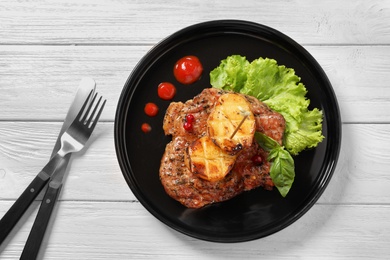 Plate with tasty grilled meat and potatoes on table, top view