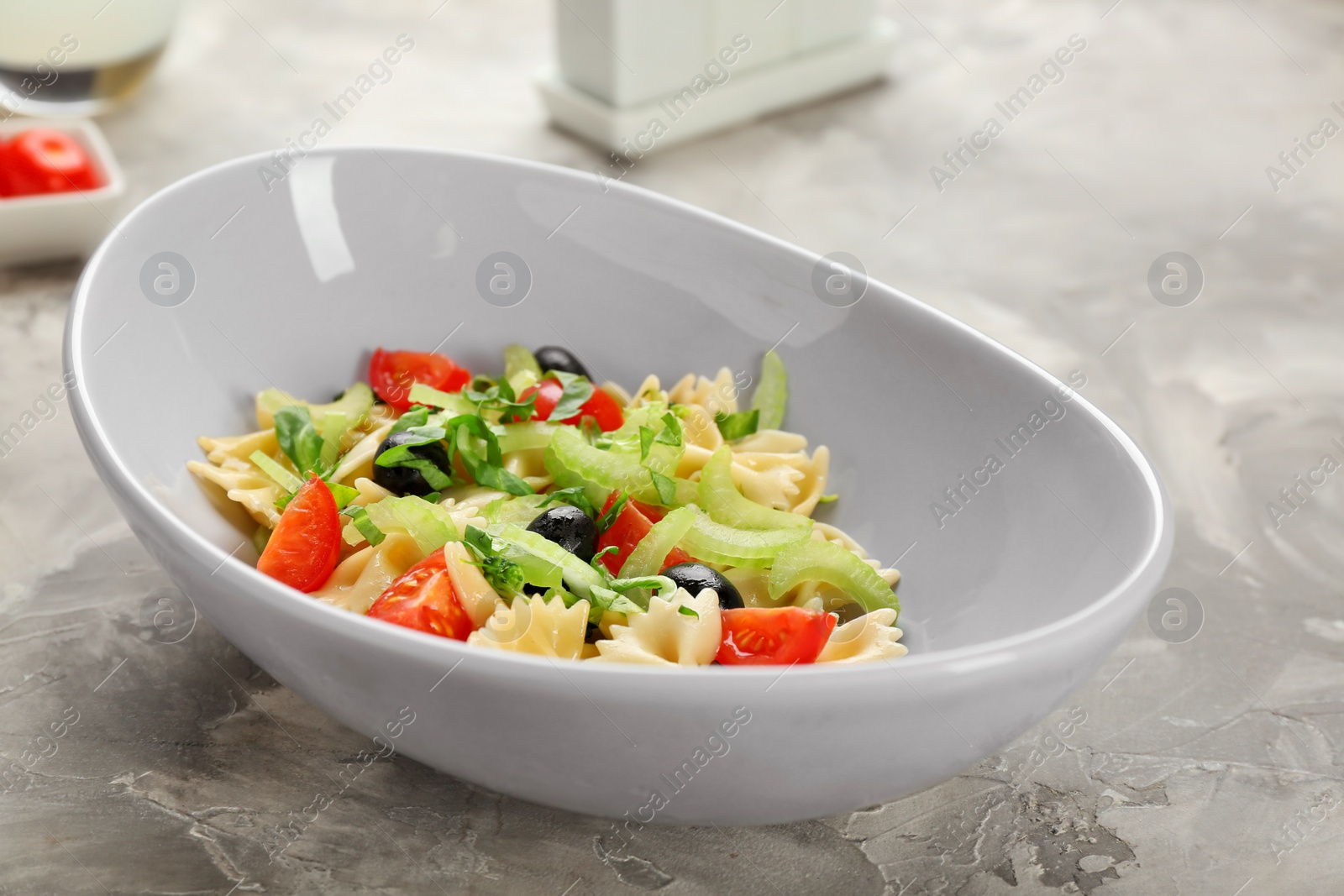 Photo of Tasty pasta salad with vegetables on table