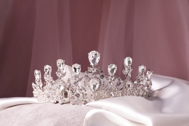 Photo of Beautiful silver tiara with diamonds on white cloth