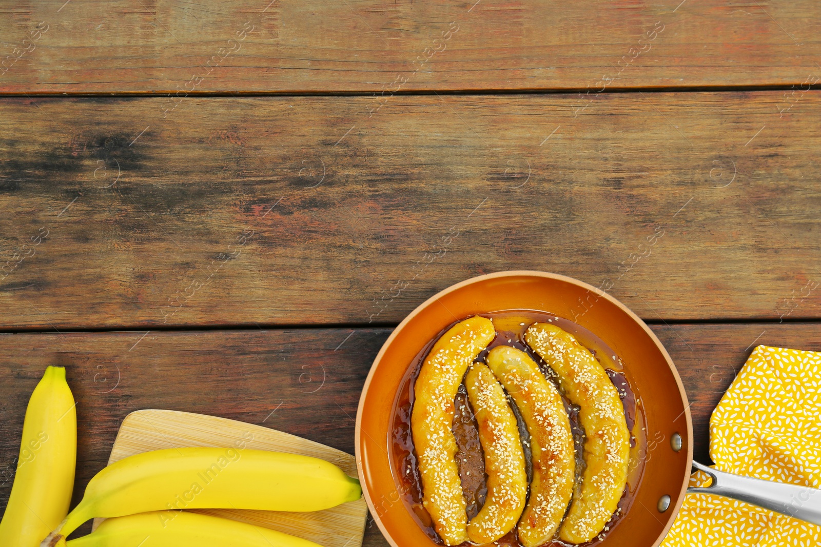 Photo of Delicious fresh and fried bananas on wooden table, flat lay. Space for text