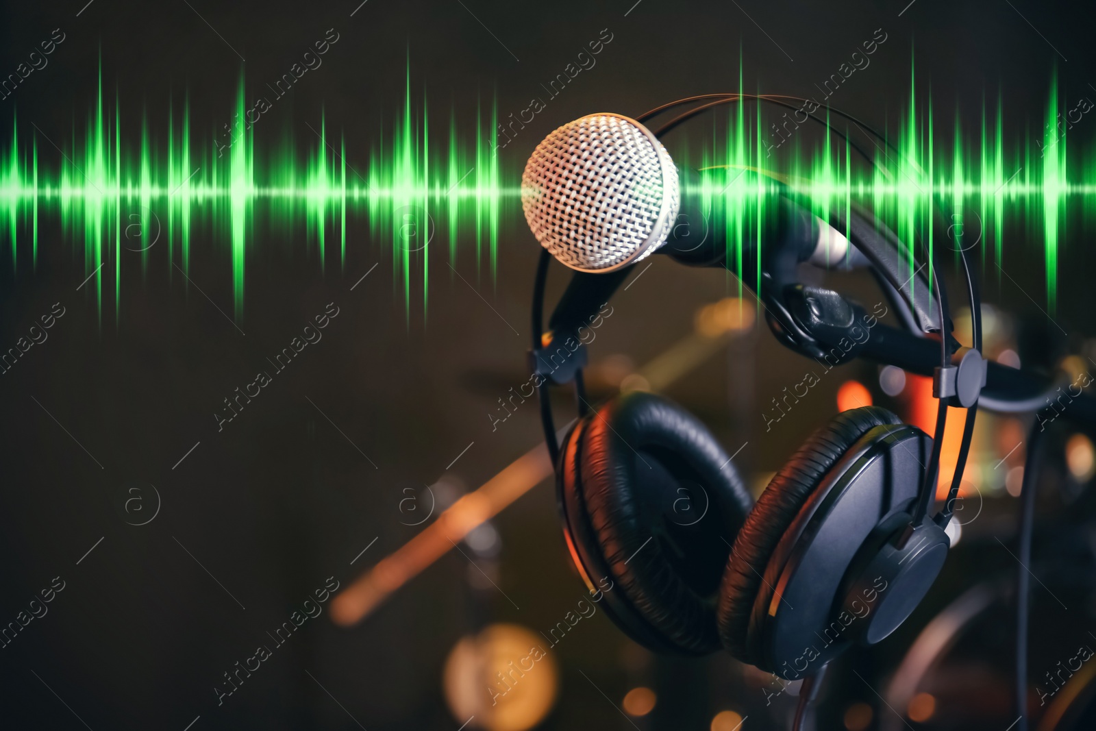 Image of Headphones, microphone and radio wave on dark background