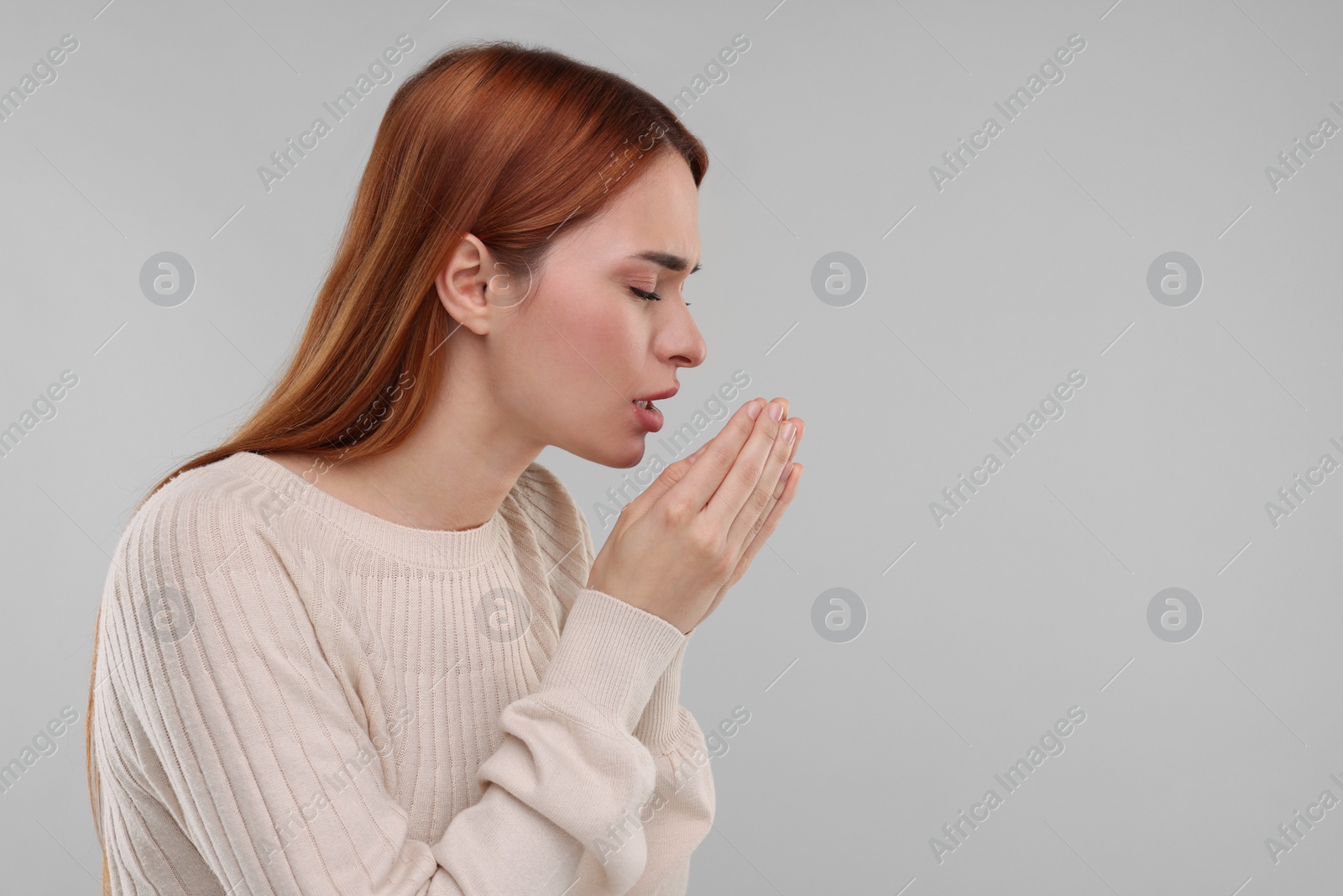 Photo of Woman coughing on light grey background, space for text. Cold symptoms