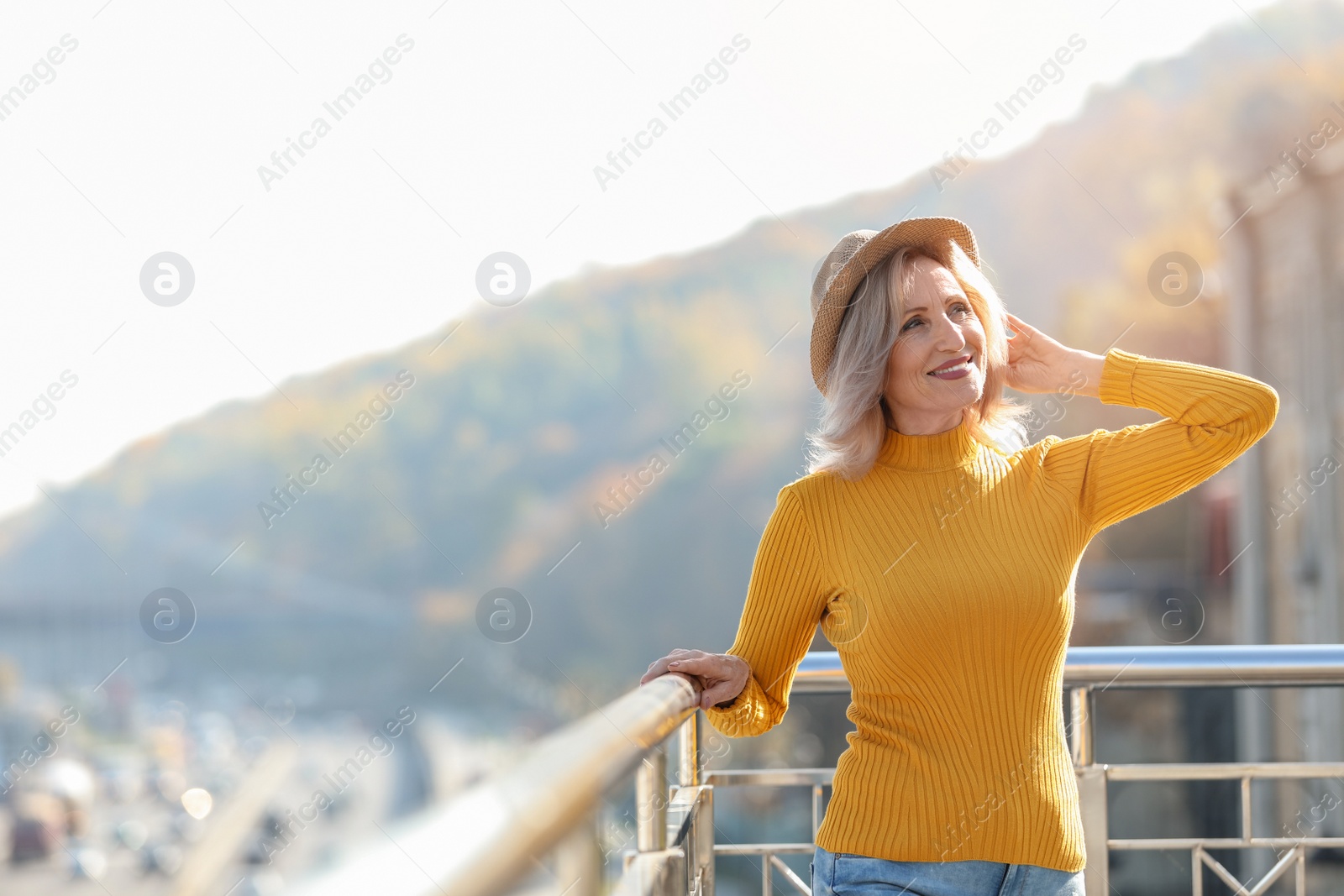 Photo of Portrait of happy mature woman on balcony, outdoors