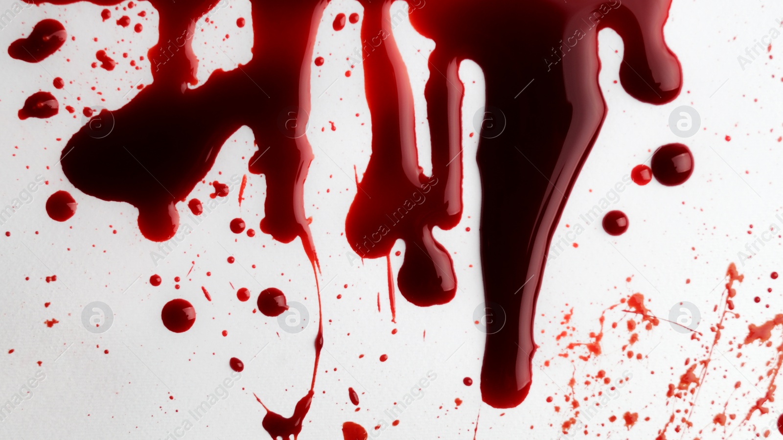 Photo of Stain and splashes of blood on light grey background