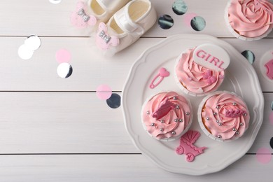 Photo of Delicious pink cupcakes on white wooden table, flat lay with space for text. Baby shower party
