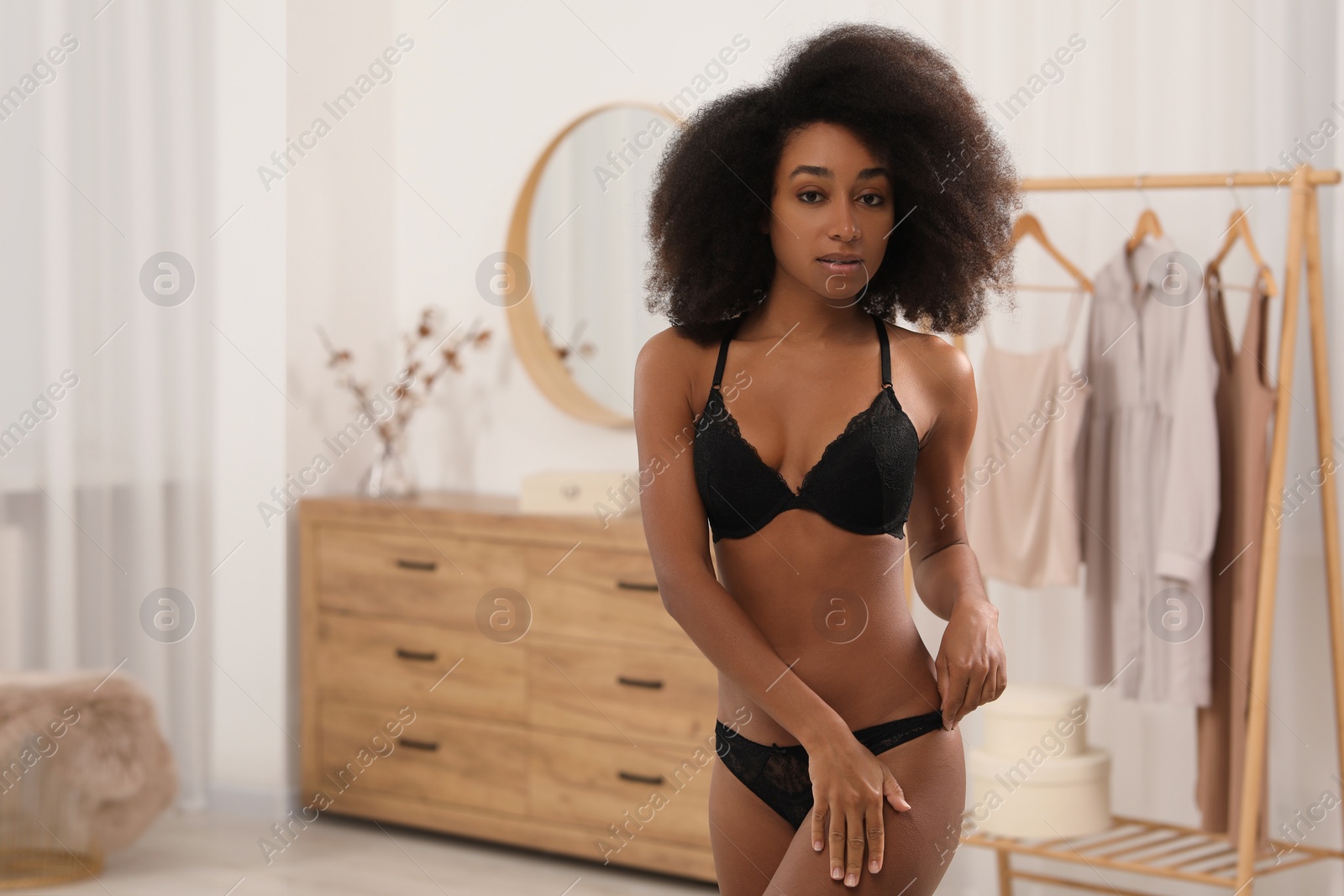Photo of Beautiful woman in elegant black underwear indoors, space for text