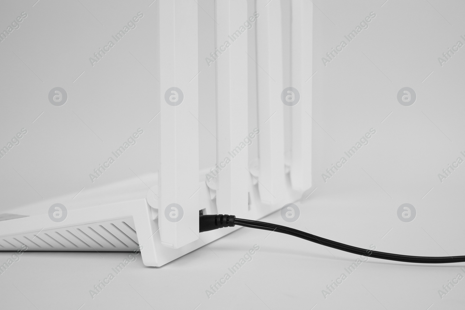 Photo of One modern Wi-Fi router on white background, closeup