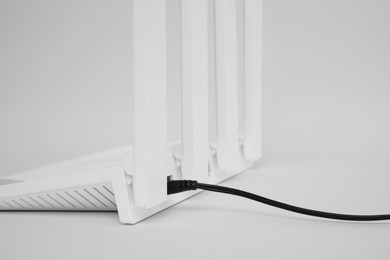 One modern Wi-Fi router on white background, closeup