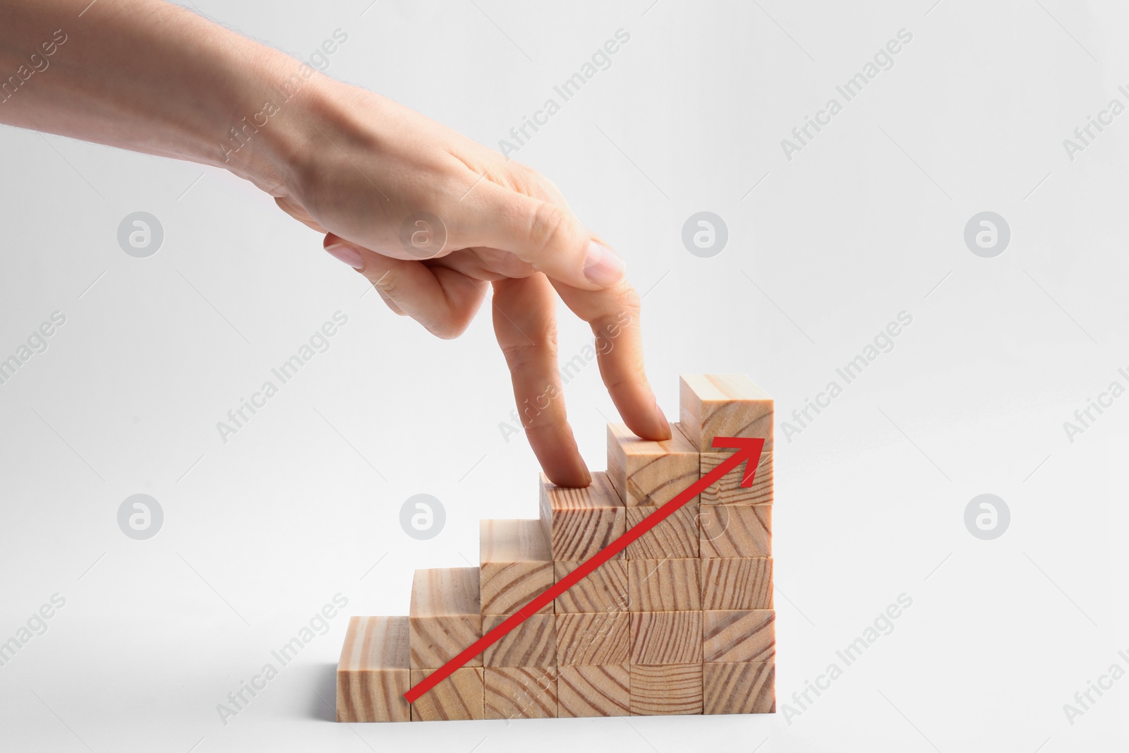 Image of Career promotion concept. Woman and stairs built with wooden blocks on white background, closeup