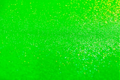 Image of St. Patrick day. Shiny green glitter, closeup. Bokeh effect