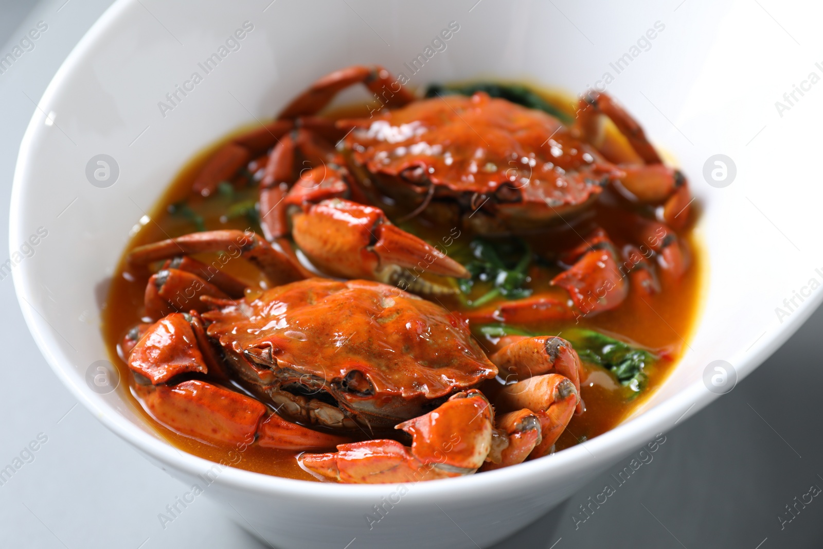 Photo of Delicious boiled crabs with sauce on table, closeup