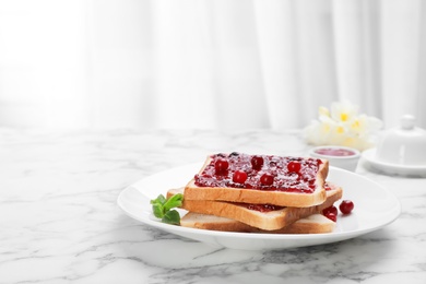 Photo of Toasts with jam and berries on plate, closeup