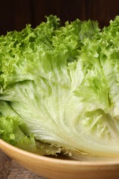 Fresh lettuce on wooden table, closeup. Salad greens