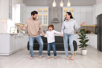 Happy family dancing and having fun at home