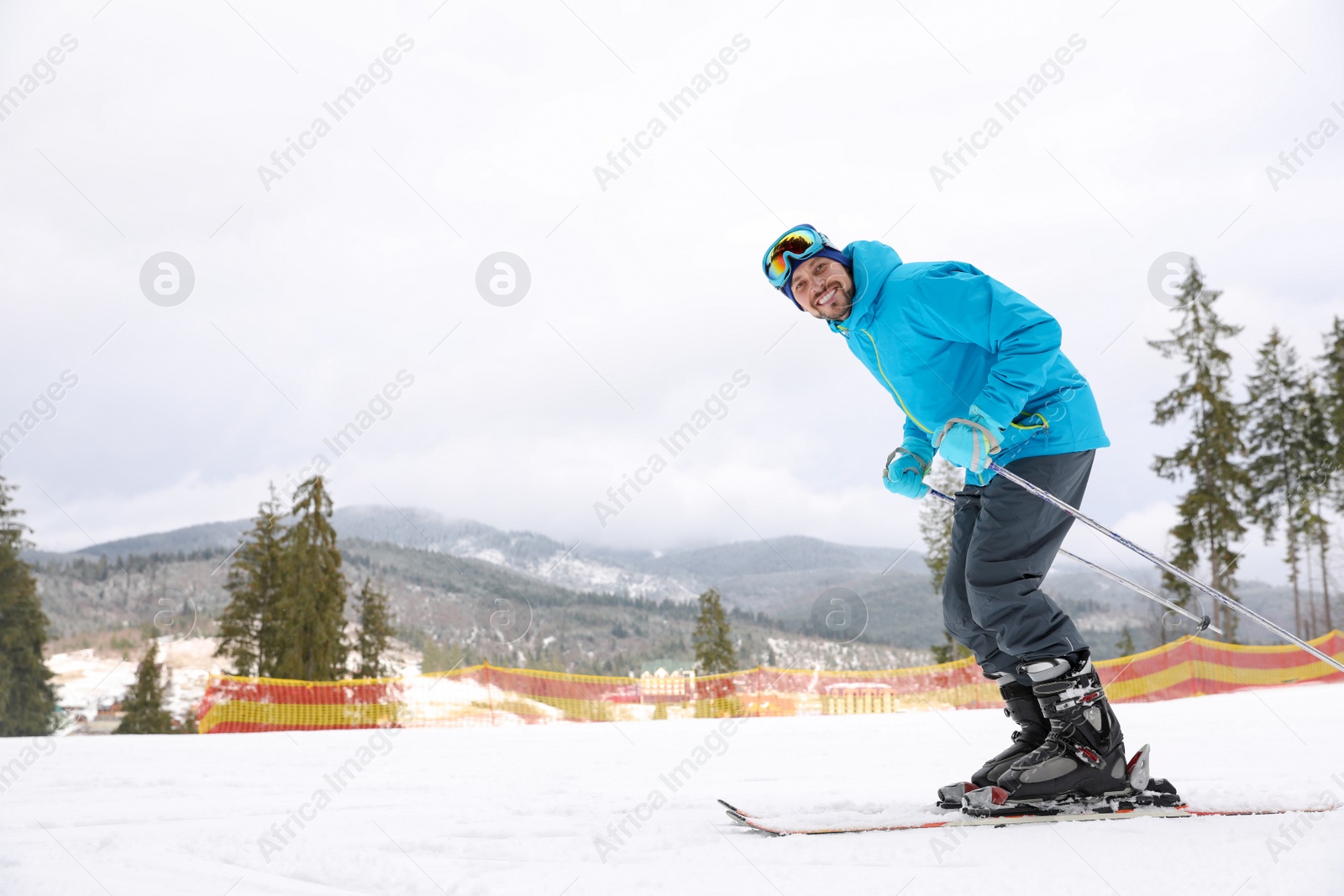 Photo of Male skier on slope at resort, space for text. Winter vacation