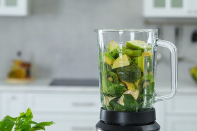 Blender with ingredients for smoothie in kitchen. Space for text