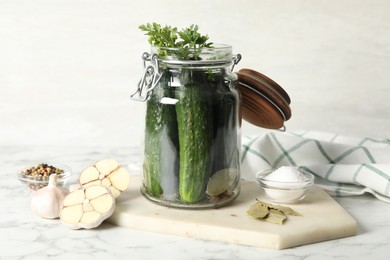 Photo of Pickling jar with fresh ripe cucumbers on white marble table