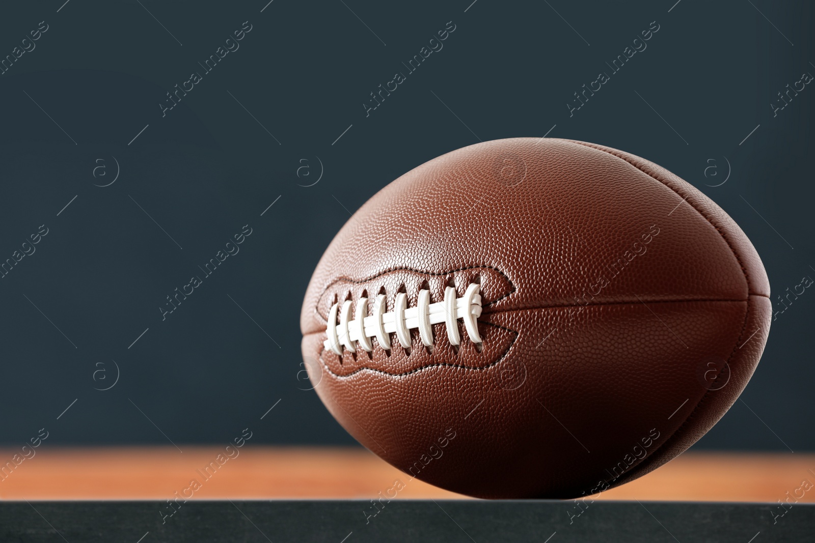 Photo of American football ball against blurred game scheme