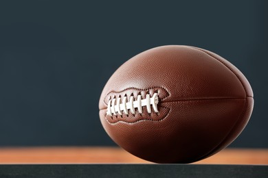 Photo of American football ball against blurred game scheme