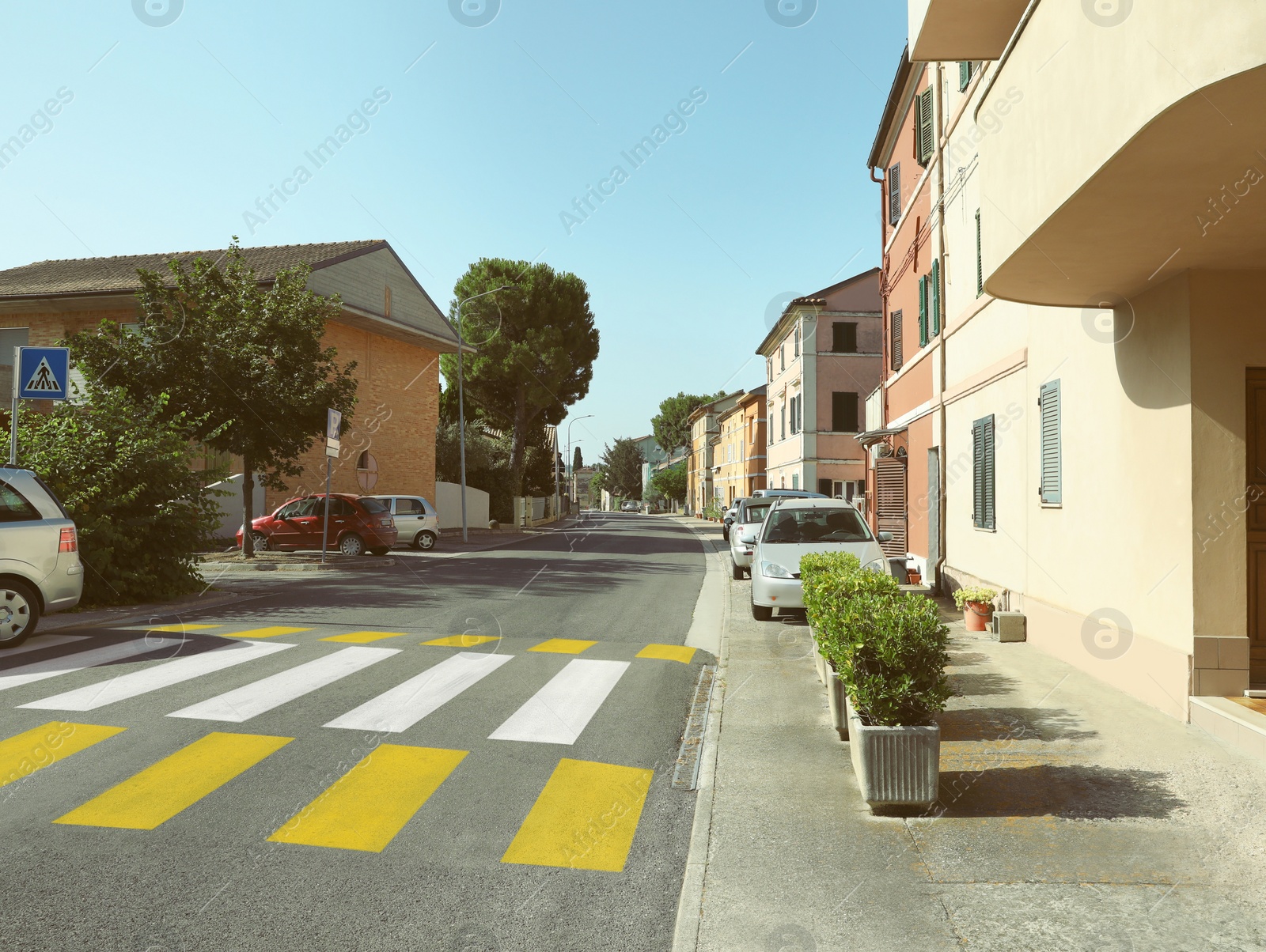 Photo of Many beautiful buildings and cars near crosswalk outdoors