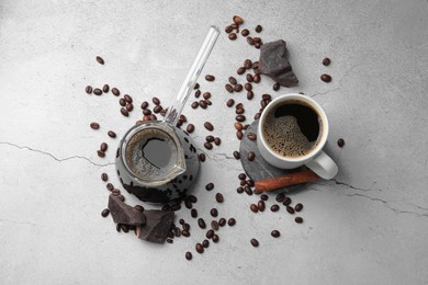 Photo of Turkish coffee. Flat lay composition with cezve and beans on light grey table
