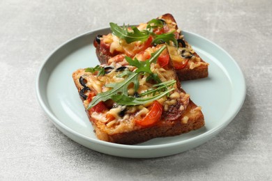 Tasty pizza toasts served on grey table