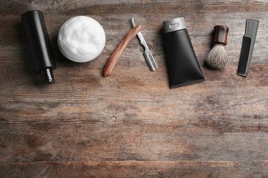 Photo of Flat lay composition with men's cosmetic products on wooden background. Space for design