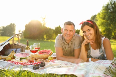 Photo of Happy couple having picnic in park on sunny day