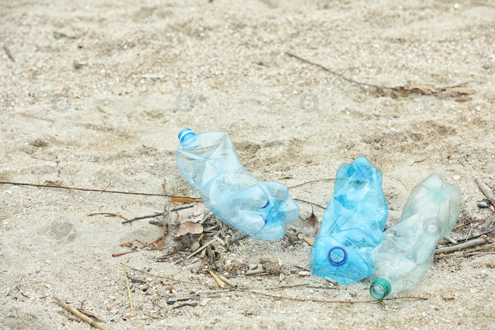 Photo of Used plastic bottles on beach, space for text. Recycling problem