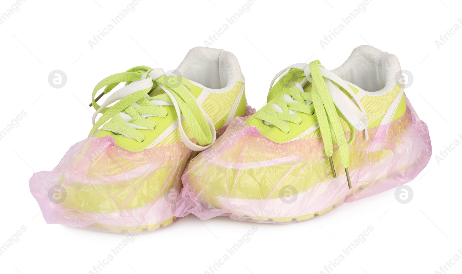 Photo of Sneakers in pink shoe covers isolated on white