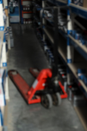 Photo of Blurred view of modern wholesale shop interior with pallet jack