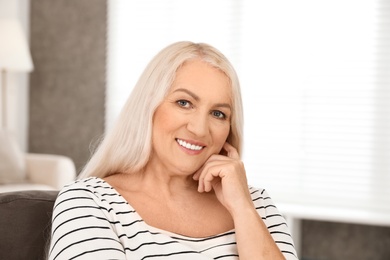 Portrait of mature woman with beautiful face indoors