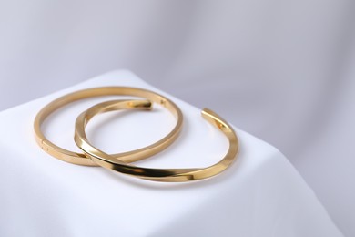 Photo of Stylish presentation of bracelets on white cloth, closeup. Space for text