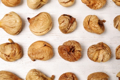 Photo of Flat lay composition with sweet figs on  wooden table. Dried fruit as healthy snack