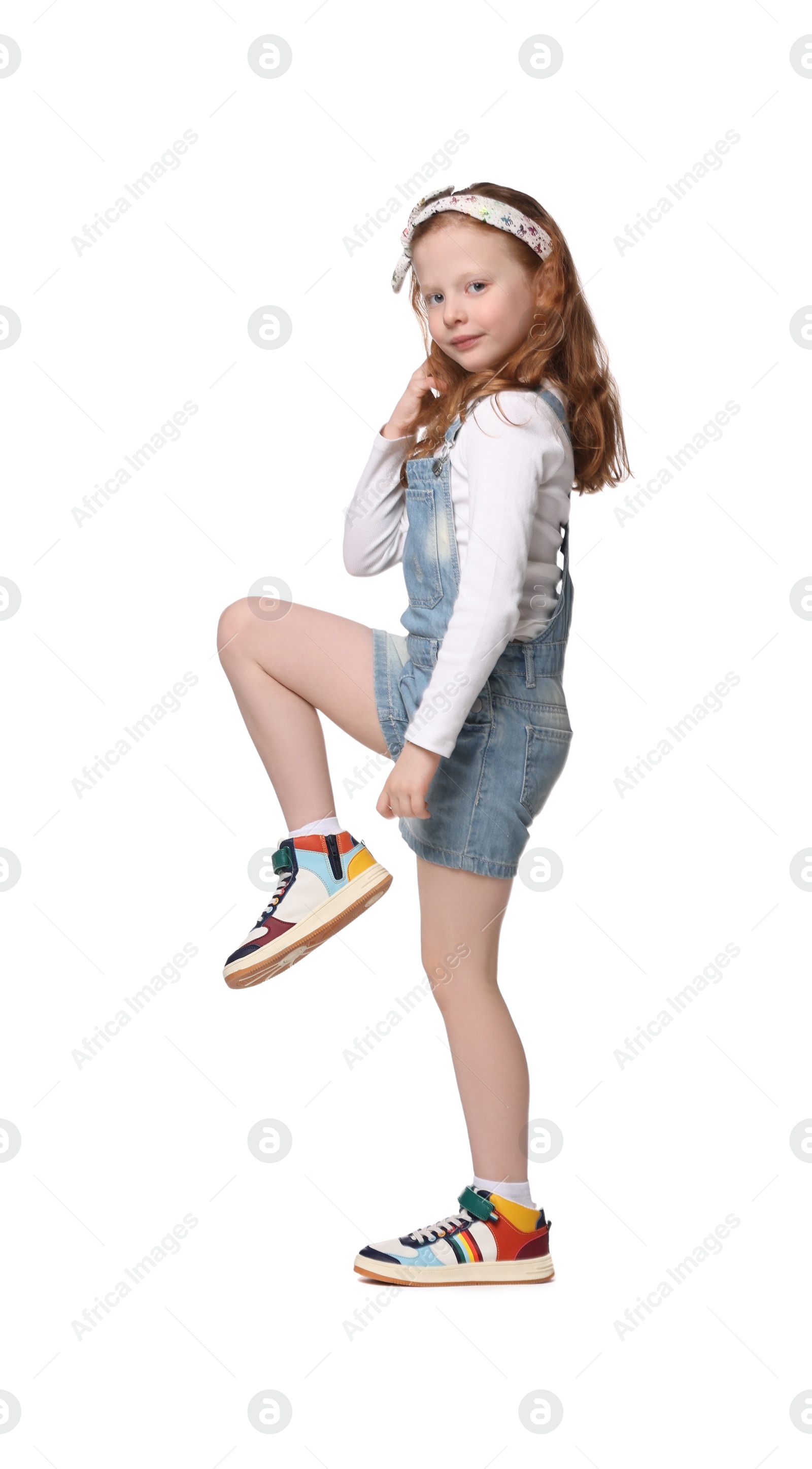 Photo of Cute little girl dancing on white background