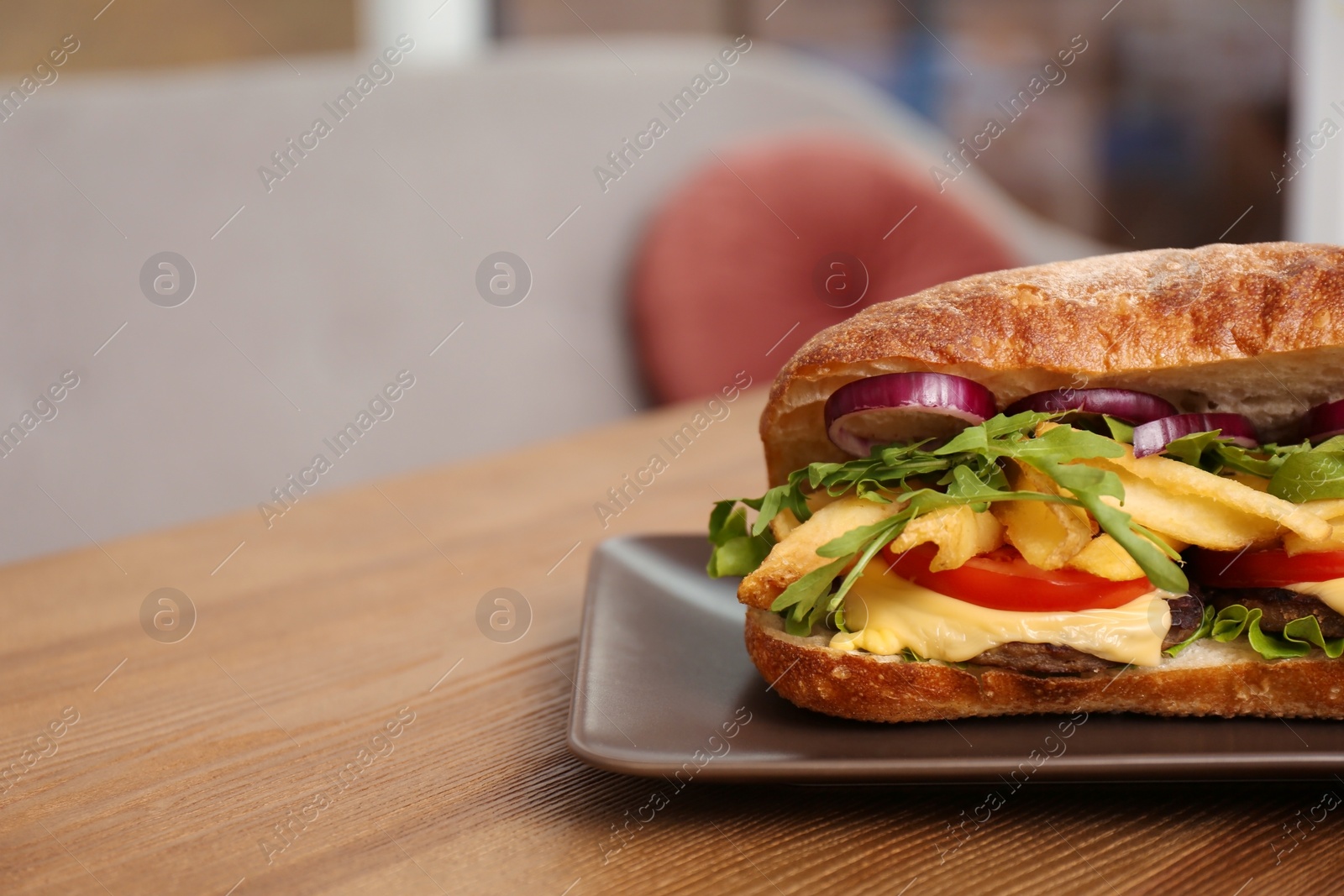 Photo of Plate with yummy sandwich on table in cafe. Space for text