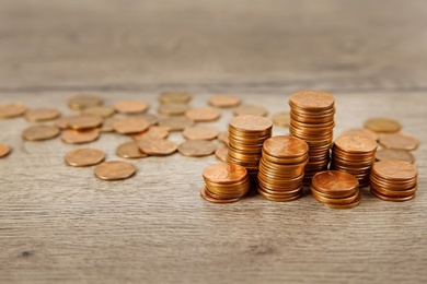 Photo of Many coins on wooden table, space for text