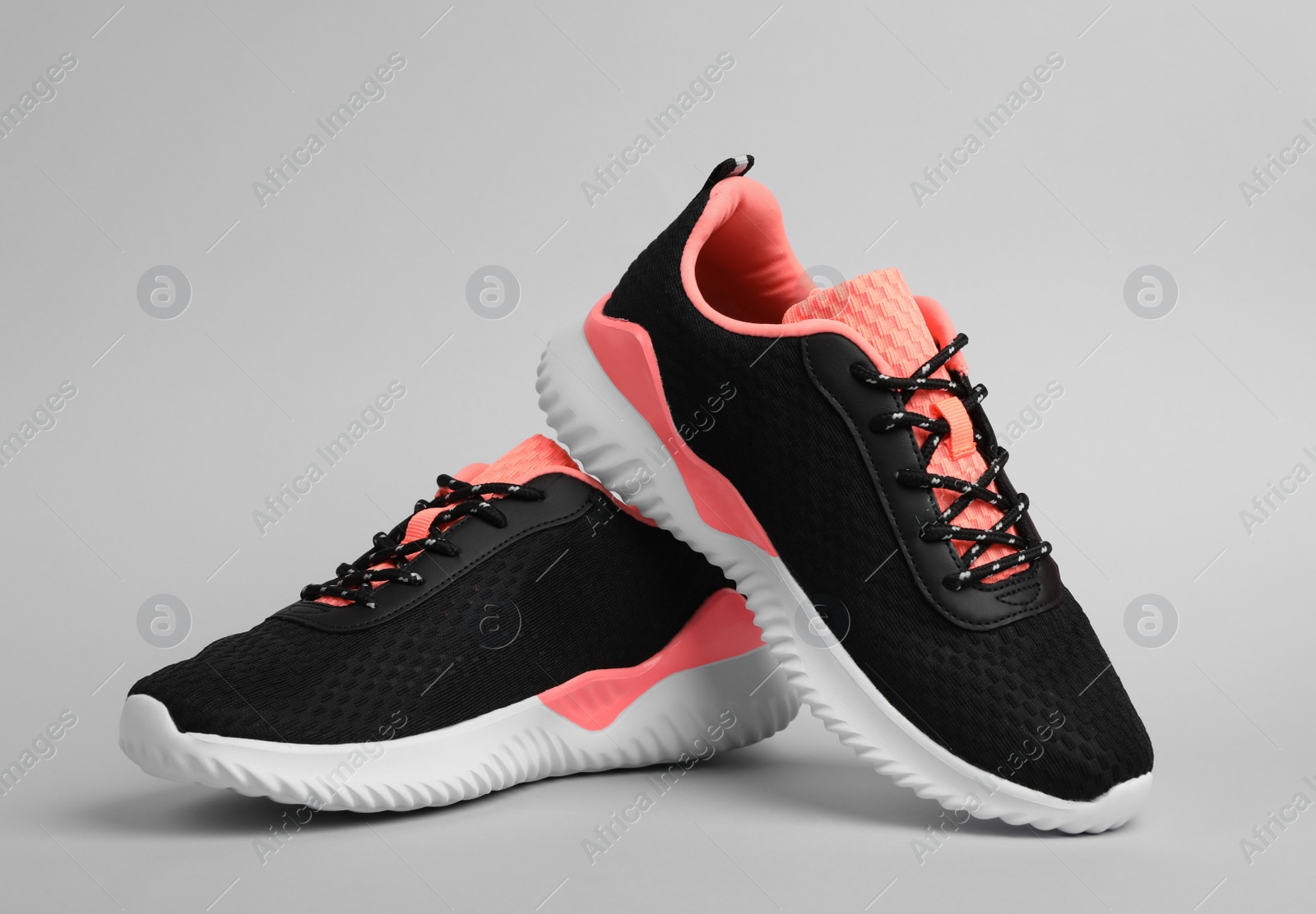 Photo of Pair of comfortable sports shoes on grey background