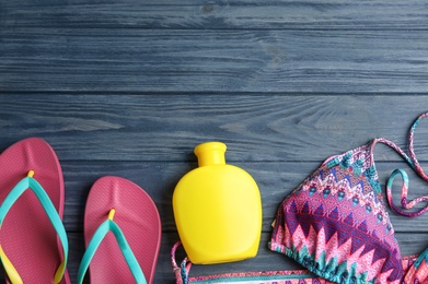 Flat lay composition with beach objects on blue wooden background. Space for text