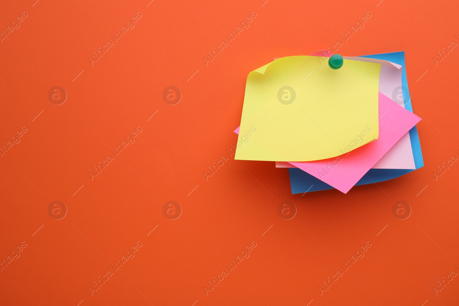 Photo of Paper notes on orange background, top view. Space for text