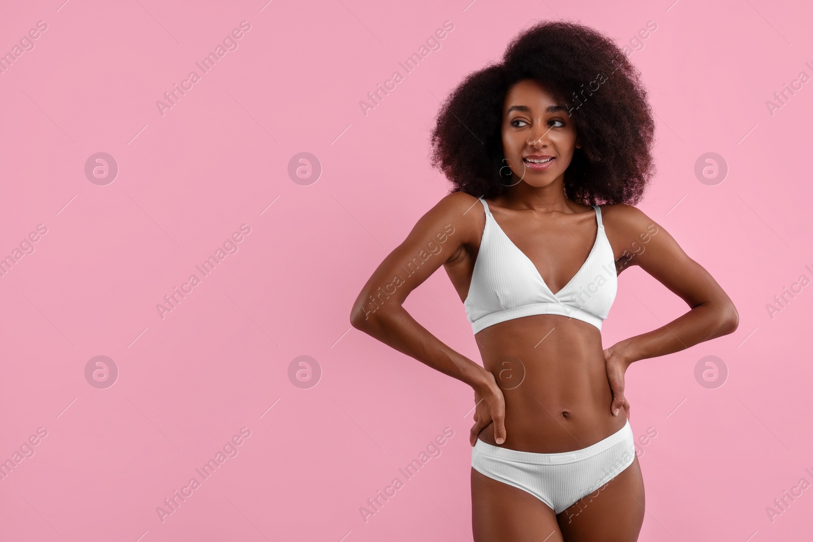 Photo of Beautiful woman in stylish bikini on pink background, space for text