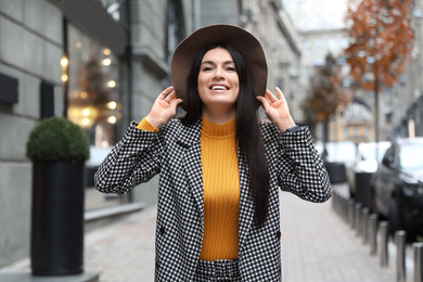 Portrait of beautiful woman in stylish suit on city street